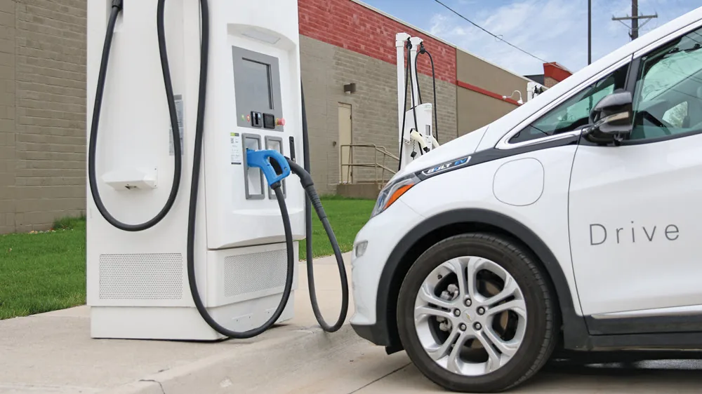 DC fast charger connected to an electric car at a public charging station